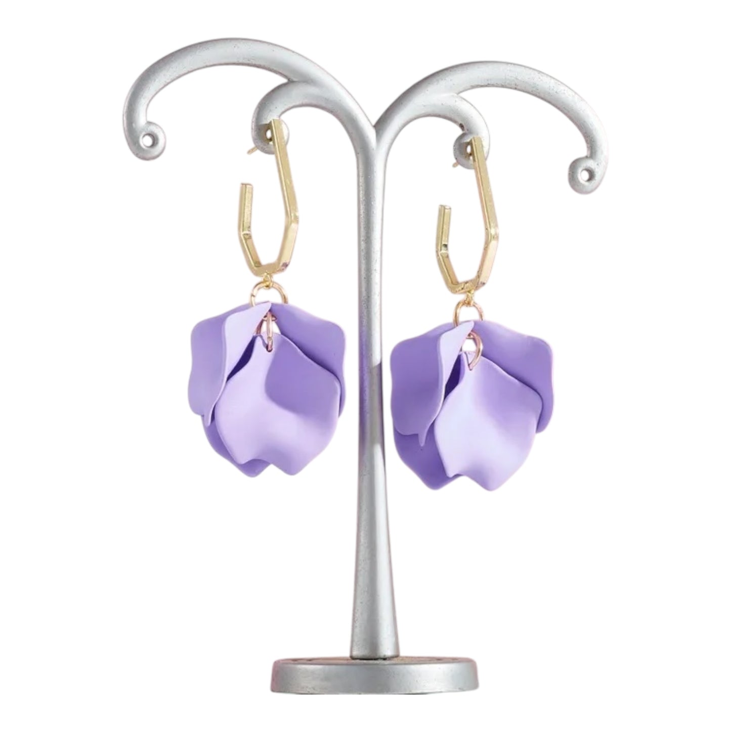 Purple flower-shaped earrings on a silver stand against a white background