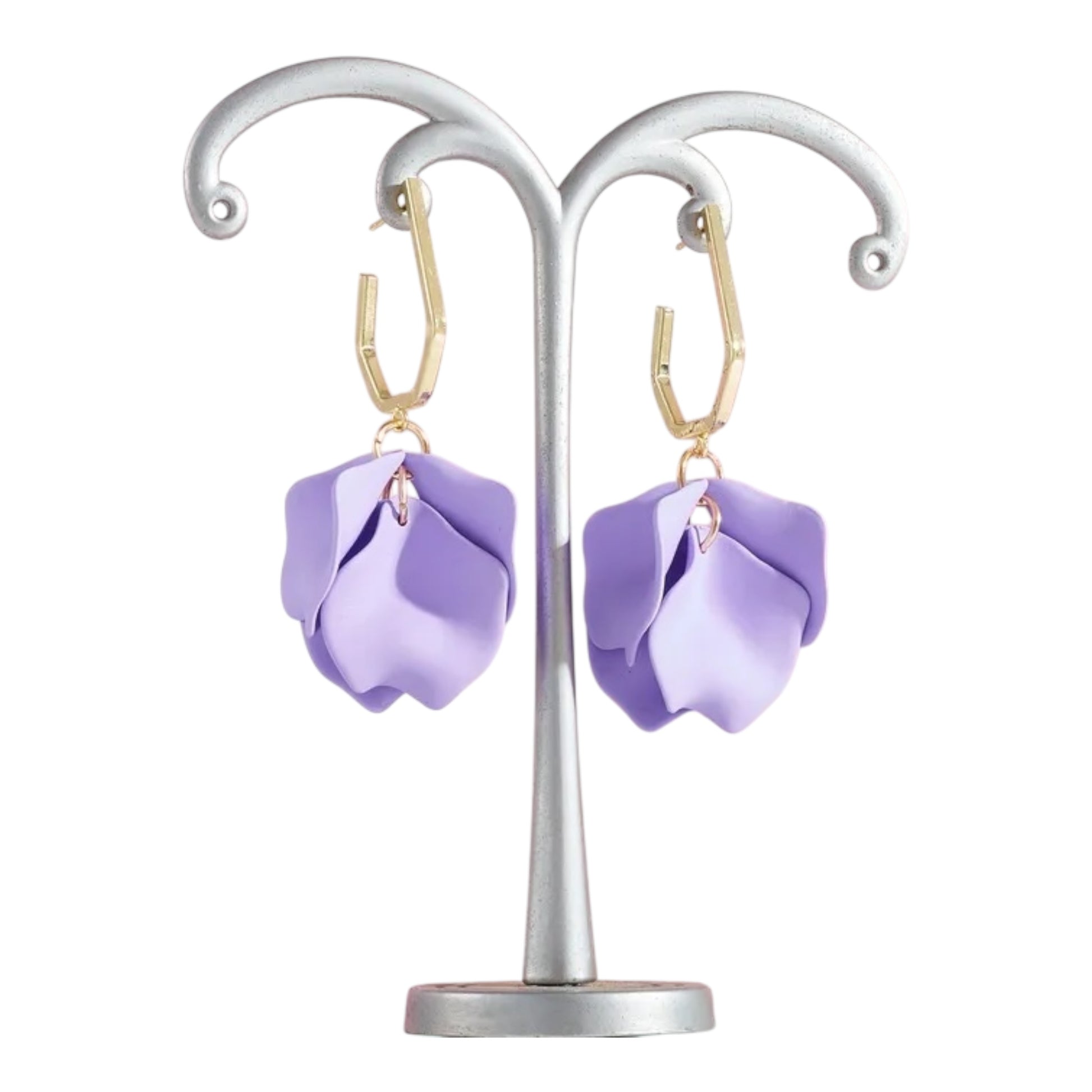 Purple flower-shaped earrings on a silver stand against a white background