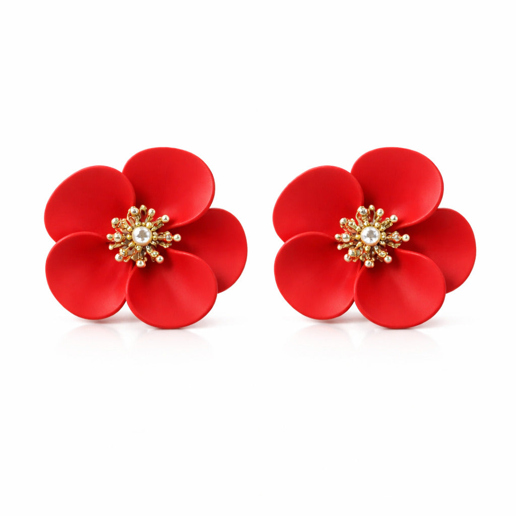 Red flower-shaped earrings with gold and pearl center on a white background
