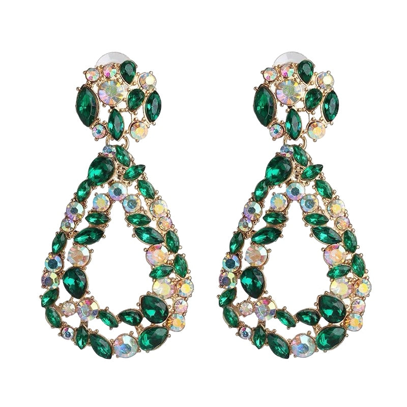 A pair of green and gold earrings with a rhinestone design.