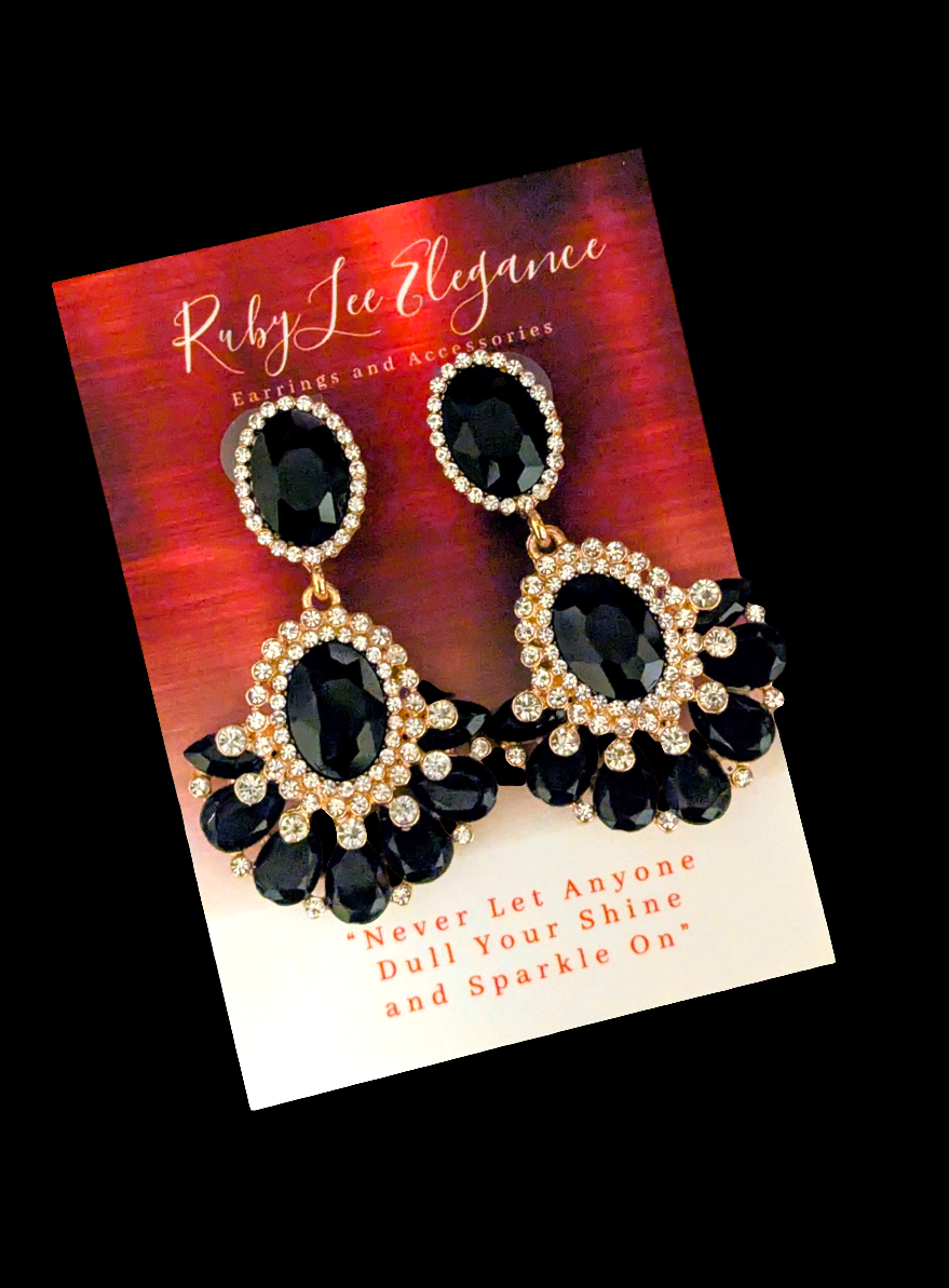 Black and gold earrings on a Ruby Lee Elegance card with red and orange gradient background.