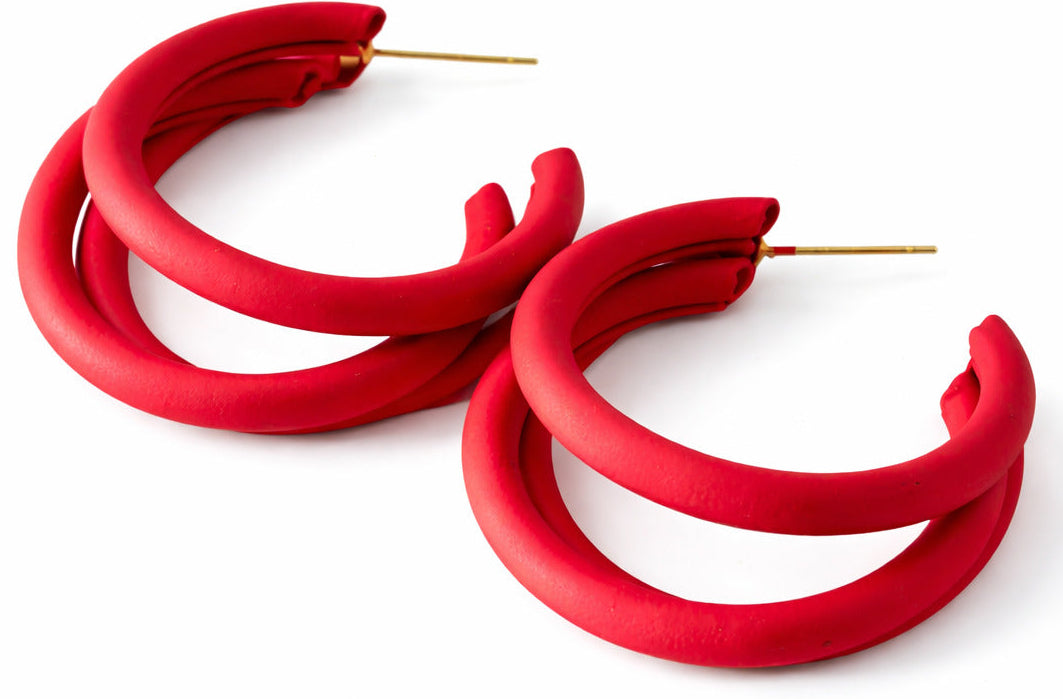 Red hoop earrings on a white background