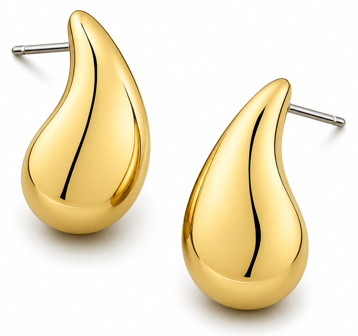 Gold teardrop earrings on a white background