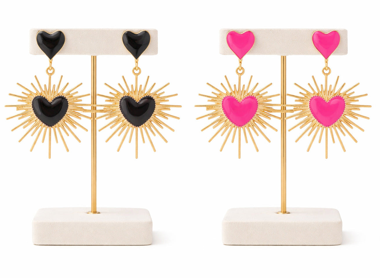 Pair of earrings with heart and sunburst designs on a white background