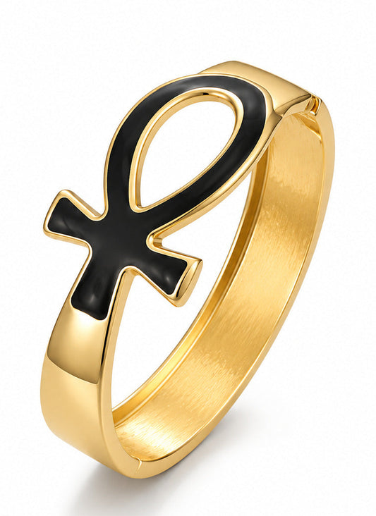 A gold-plated bracelet featuring a black enamel Ankh symbol on a clean white background.