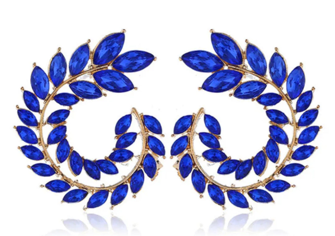 Pair of blue leaf-shaped earrings with gold accents on a white background