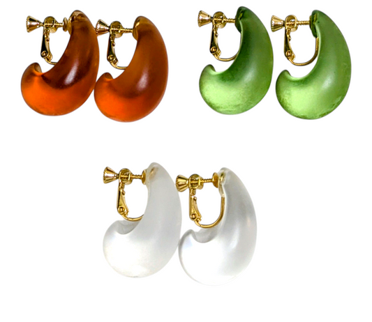 Set of three pairs of hoop earrings in orange, green, and white with gold clasps on a white background.