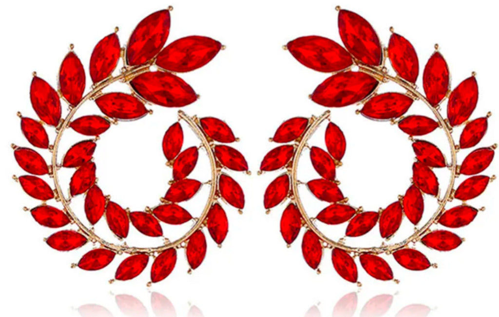 Pair of red leaf-shaped earrings on a white background