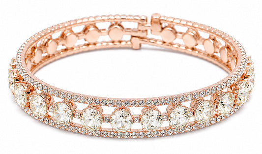A rose gold bangle bracelet featuring rows of clear round-cut stones and pavé-set small stones, shown on a plain white background.