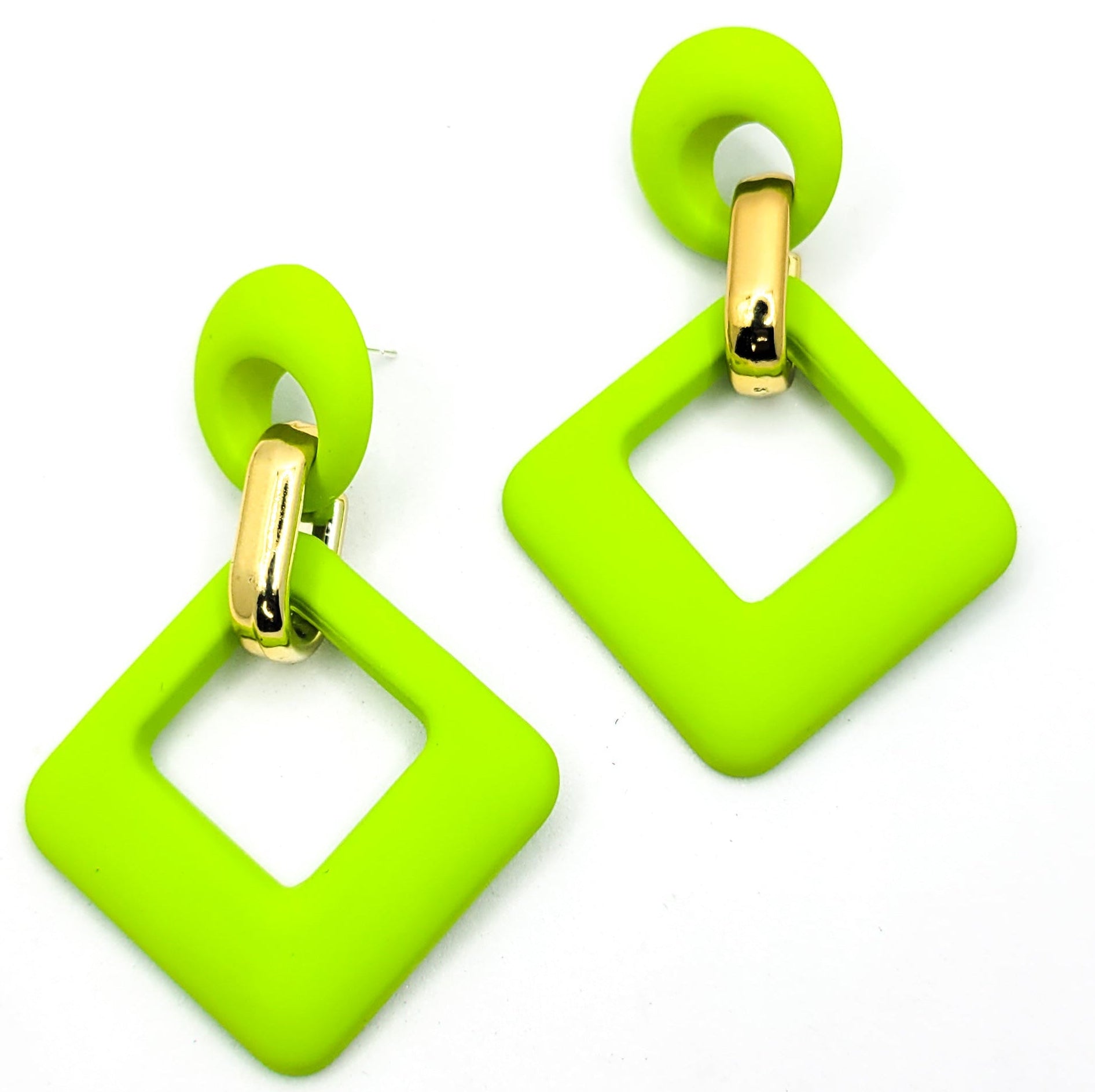 A pair of green velvet rhombus-shaped earrings with gold clip attachments, displayed against a white background.