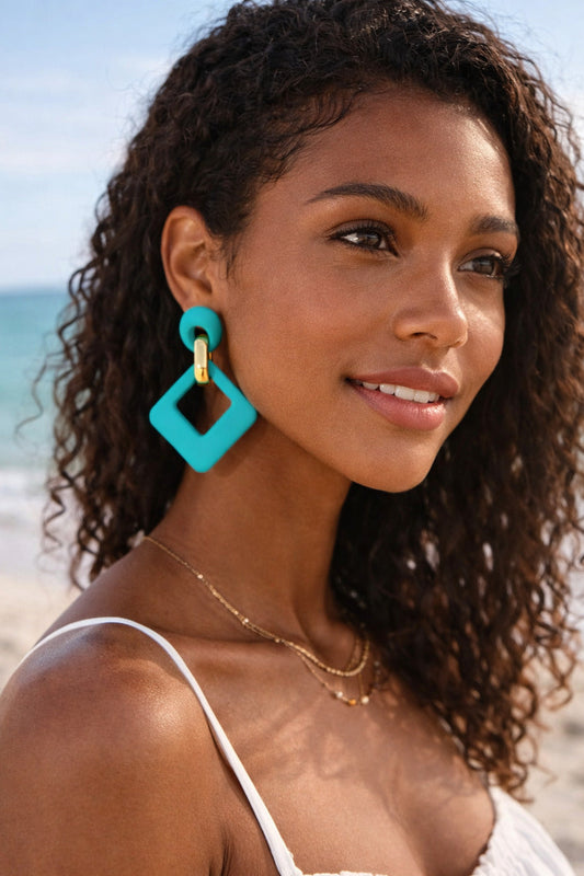 Woman wearing turquoise earrings on a beach